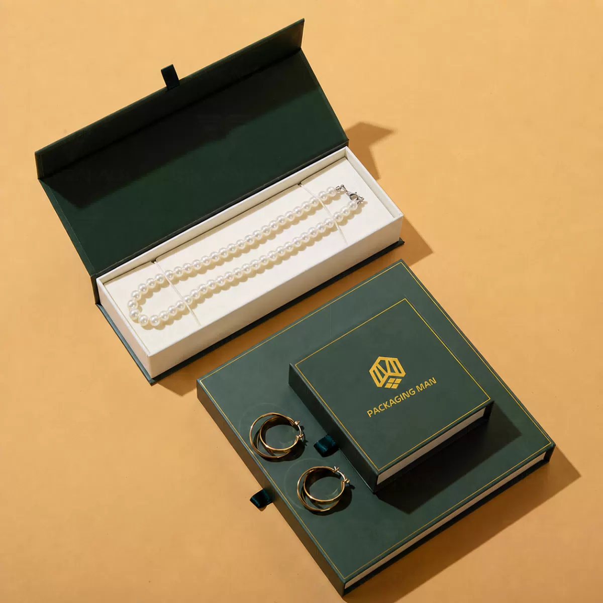 Open green gift box with pearl necklace insert