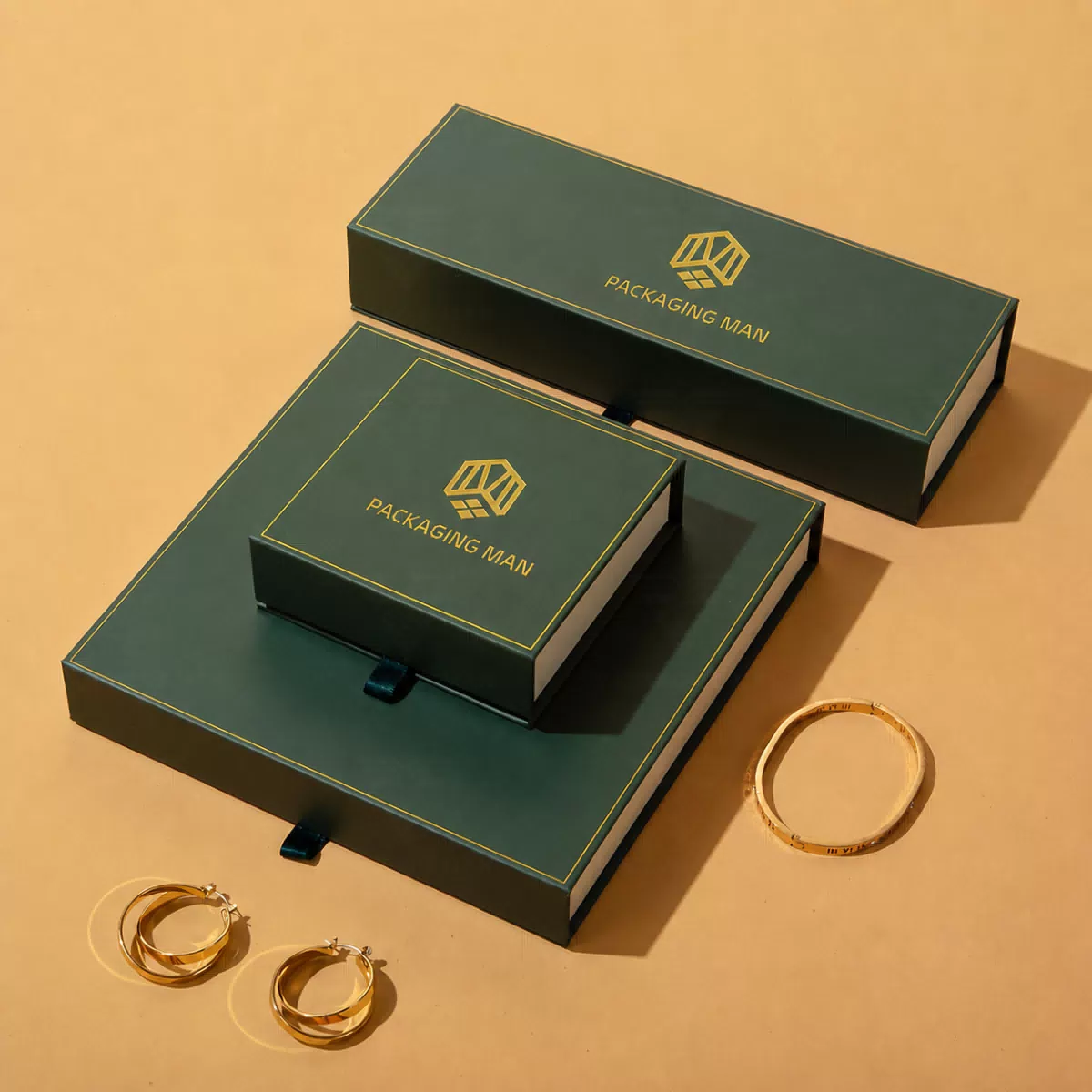 Stacked dark green rigid boxes with accessories