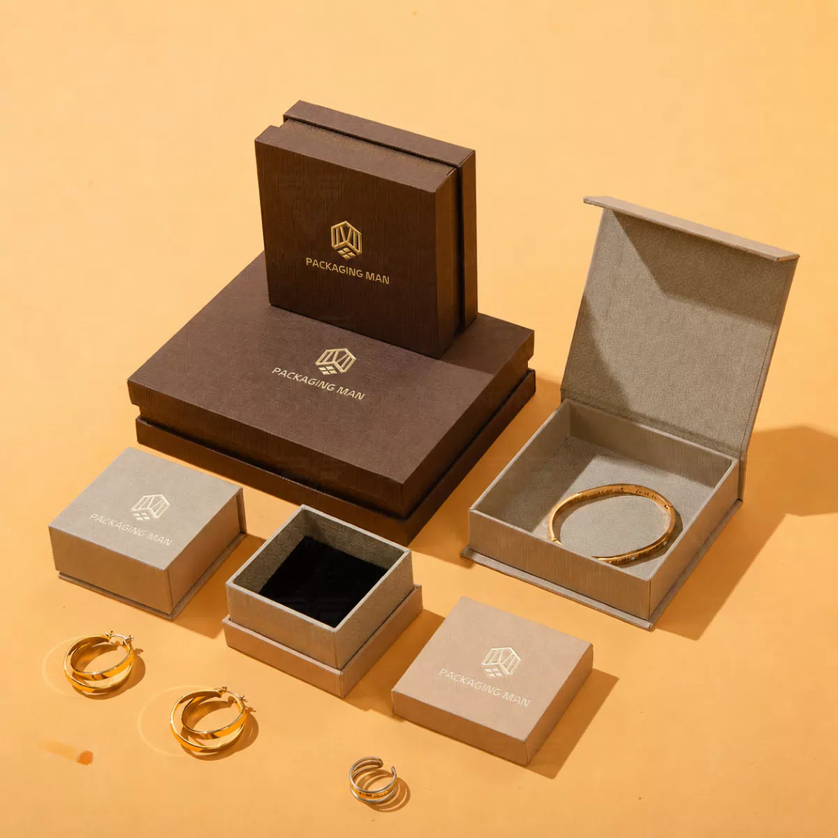 Stacked brown and grey rigid gift boxes