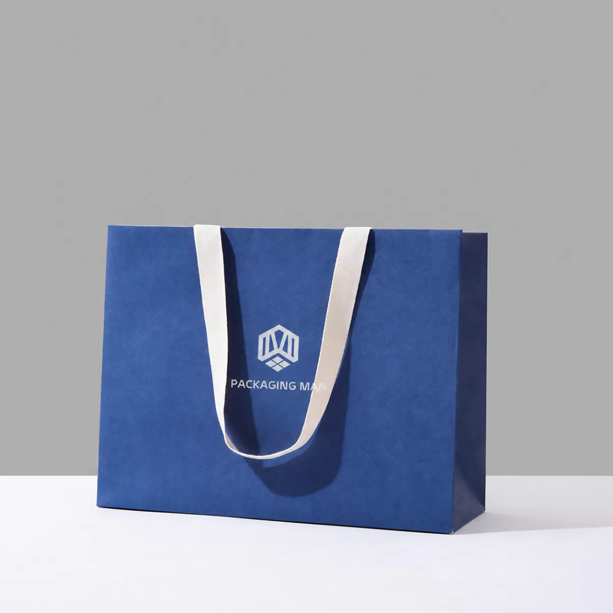 Angled view of blue paper shopping bag