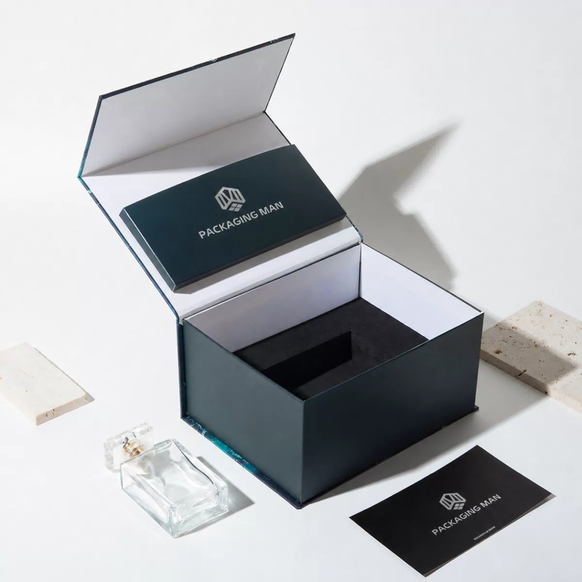 Open dark rigid box with inner tray