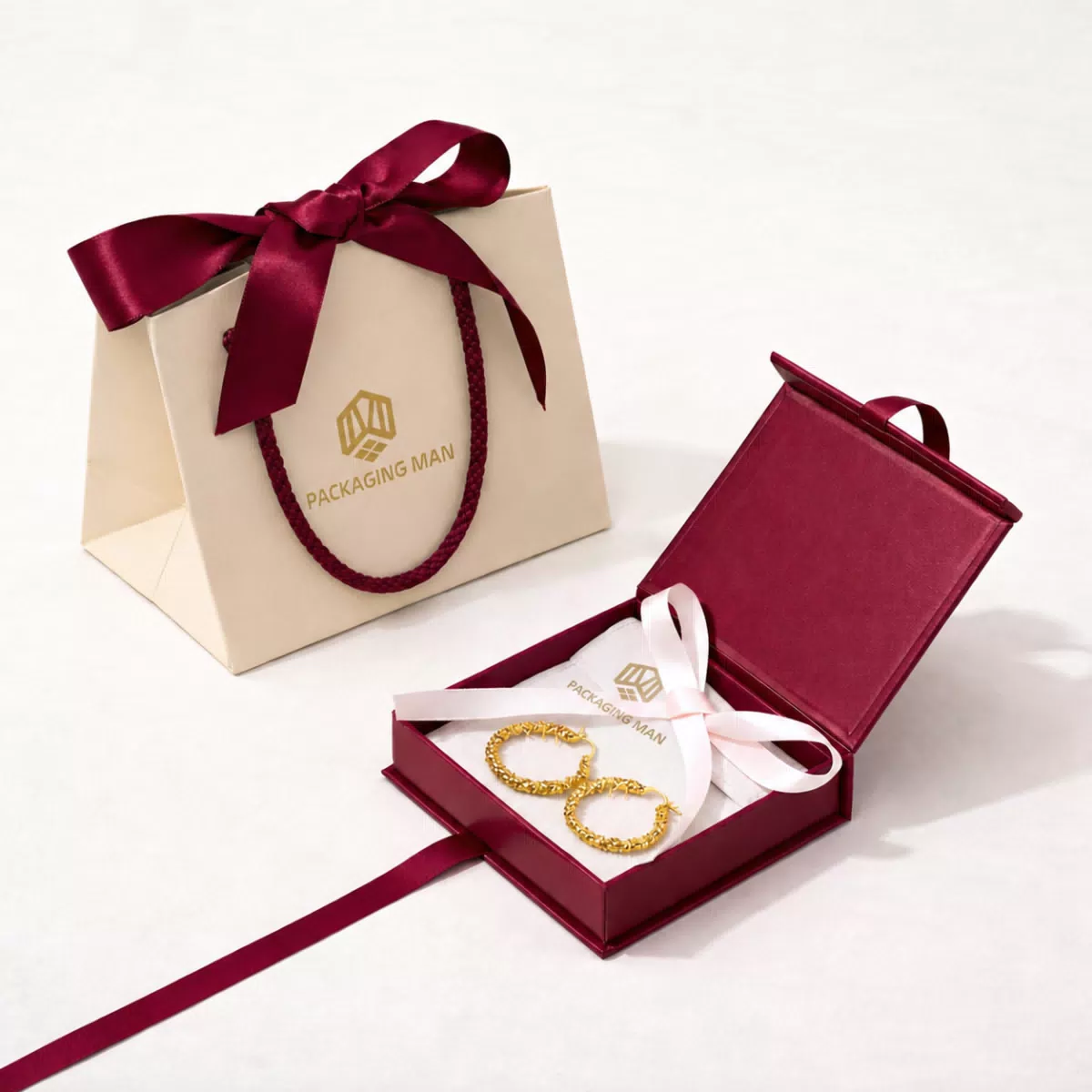 Open burgundy gift box with jewelry inside
