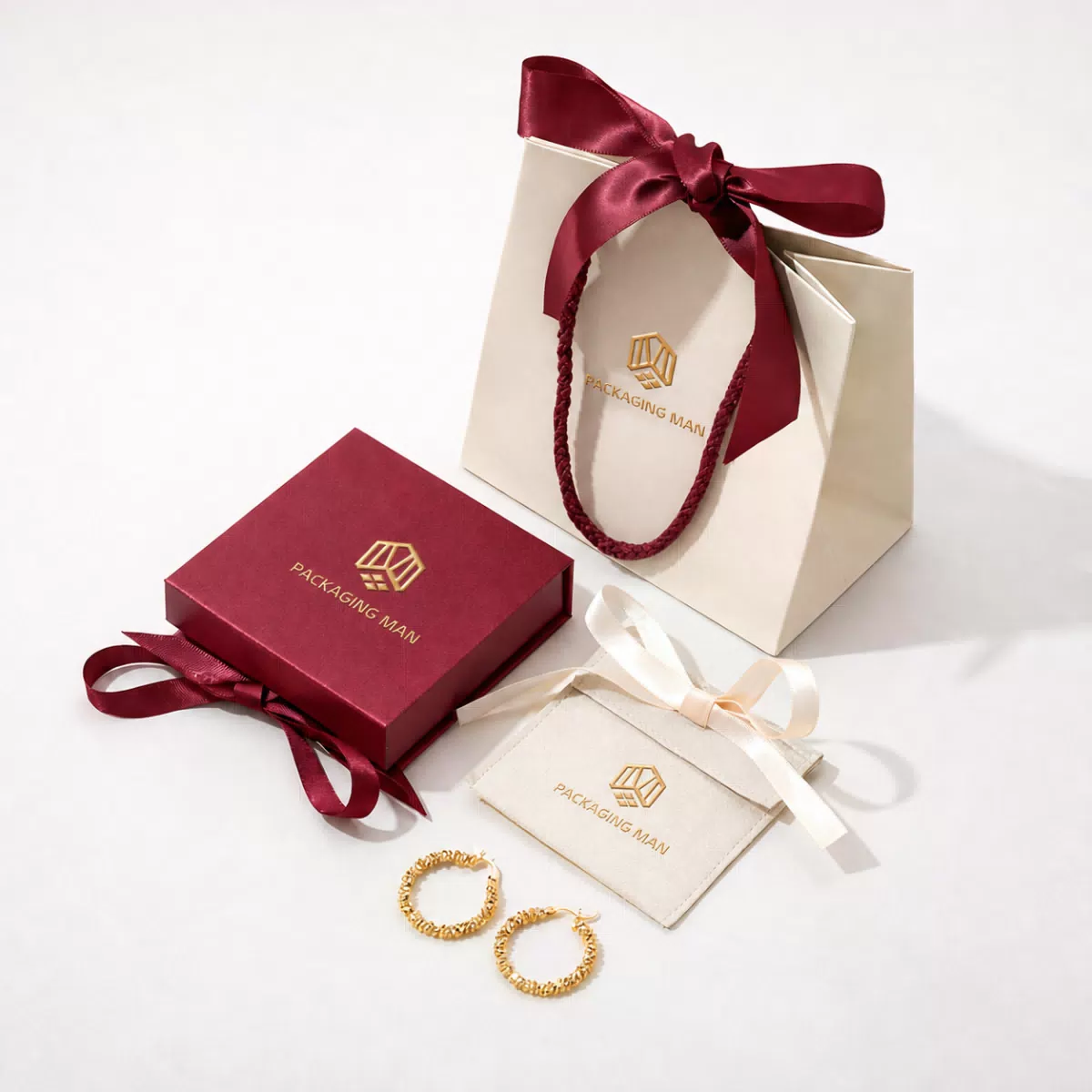 Closed burgundy gift box and cream paper bag