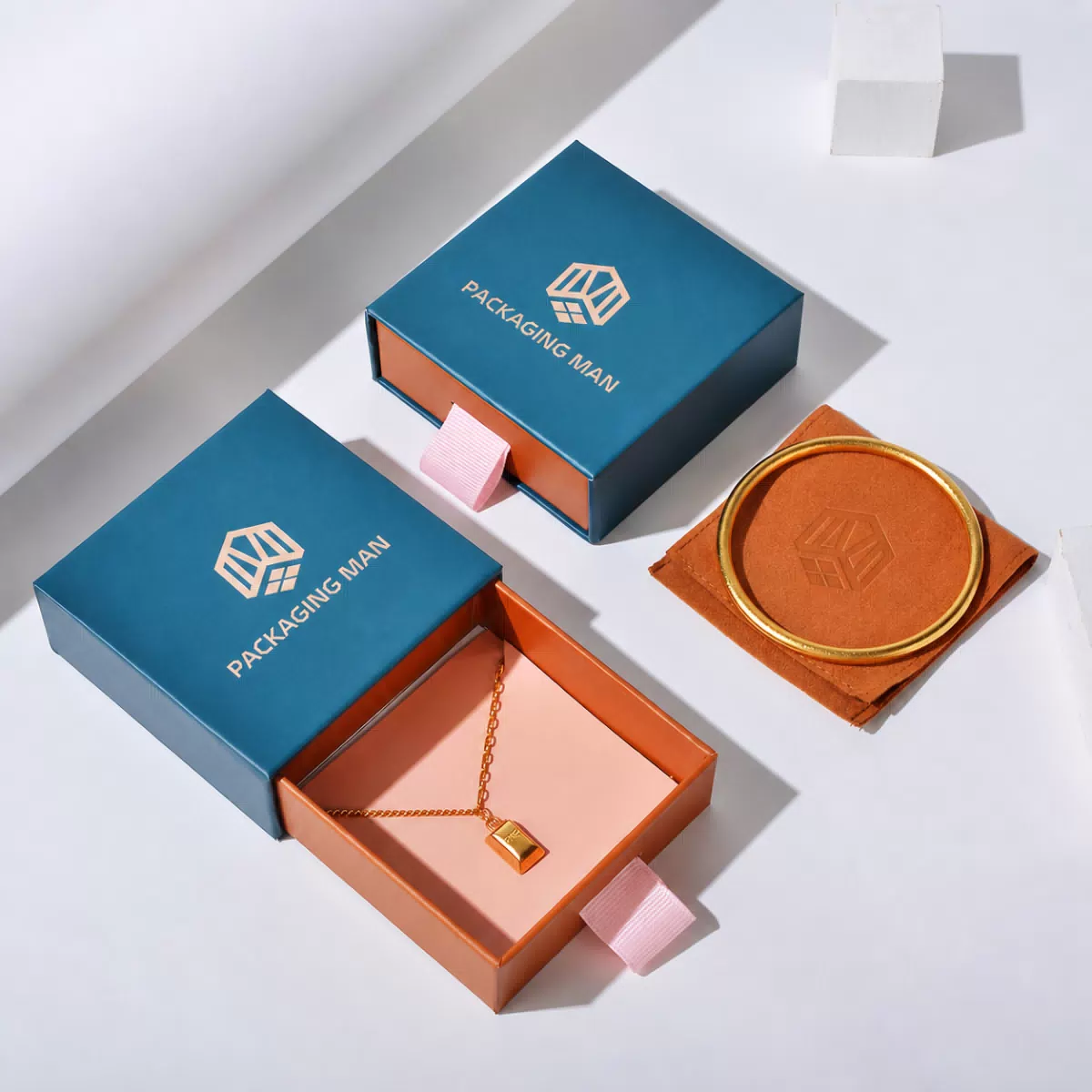 Open teal drawer box with orange interior