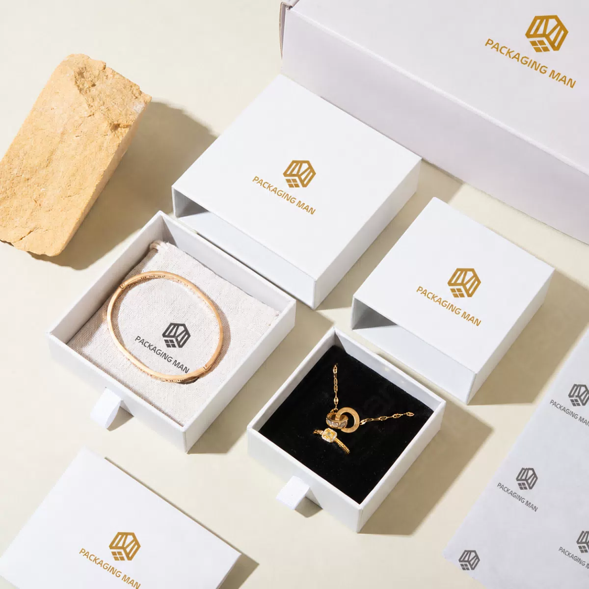 White rigid boxes containing jewelry items