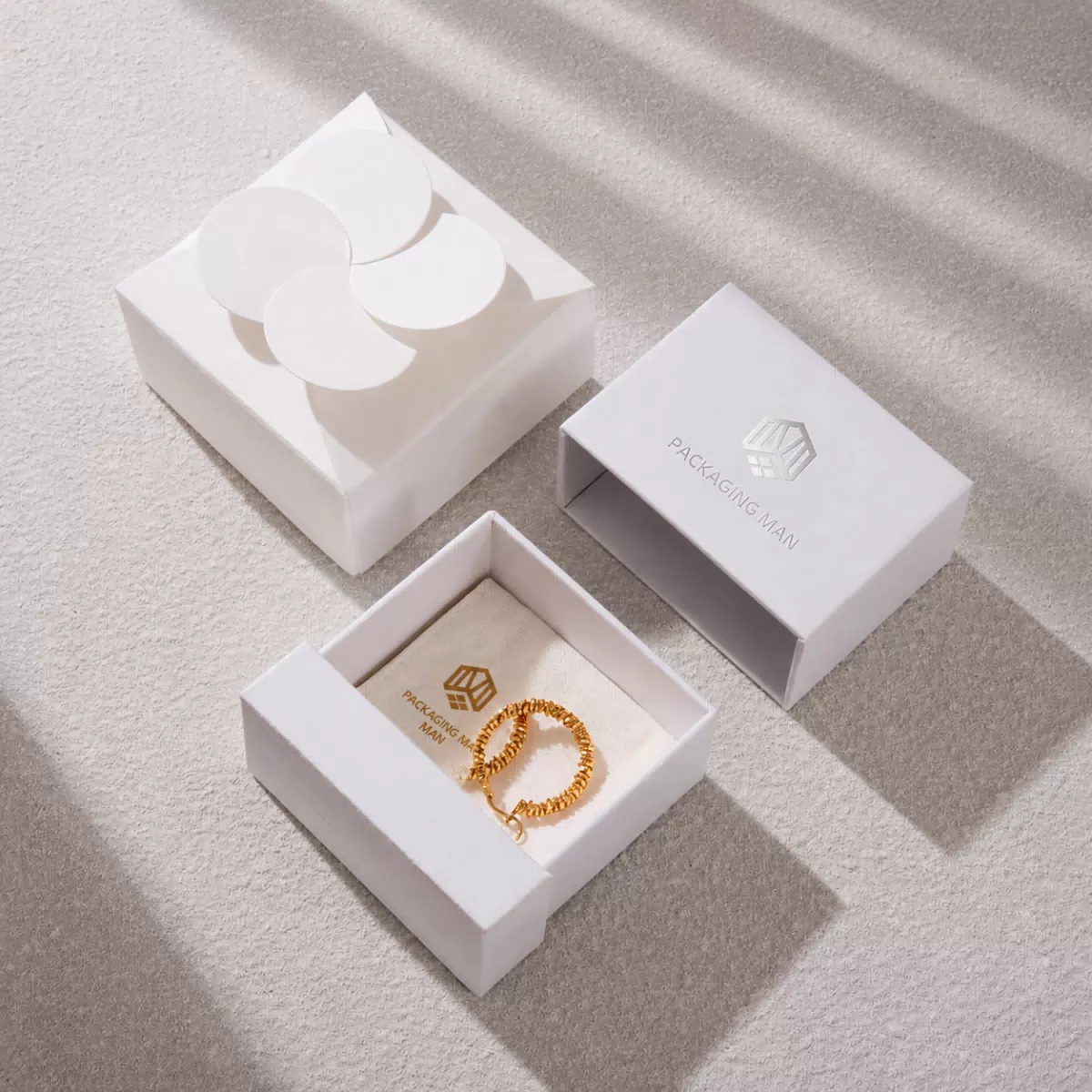 White drawer box packaging with gold bracelet