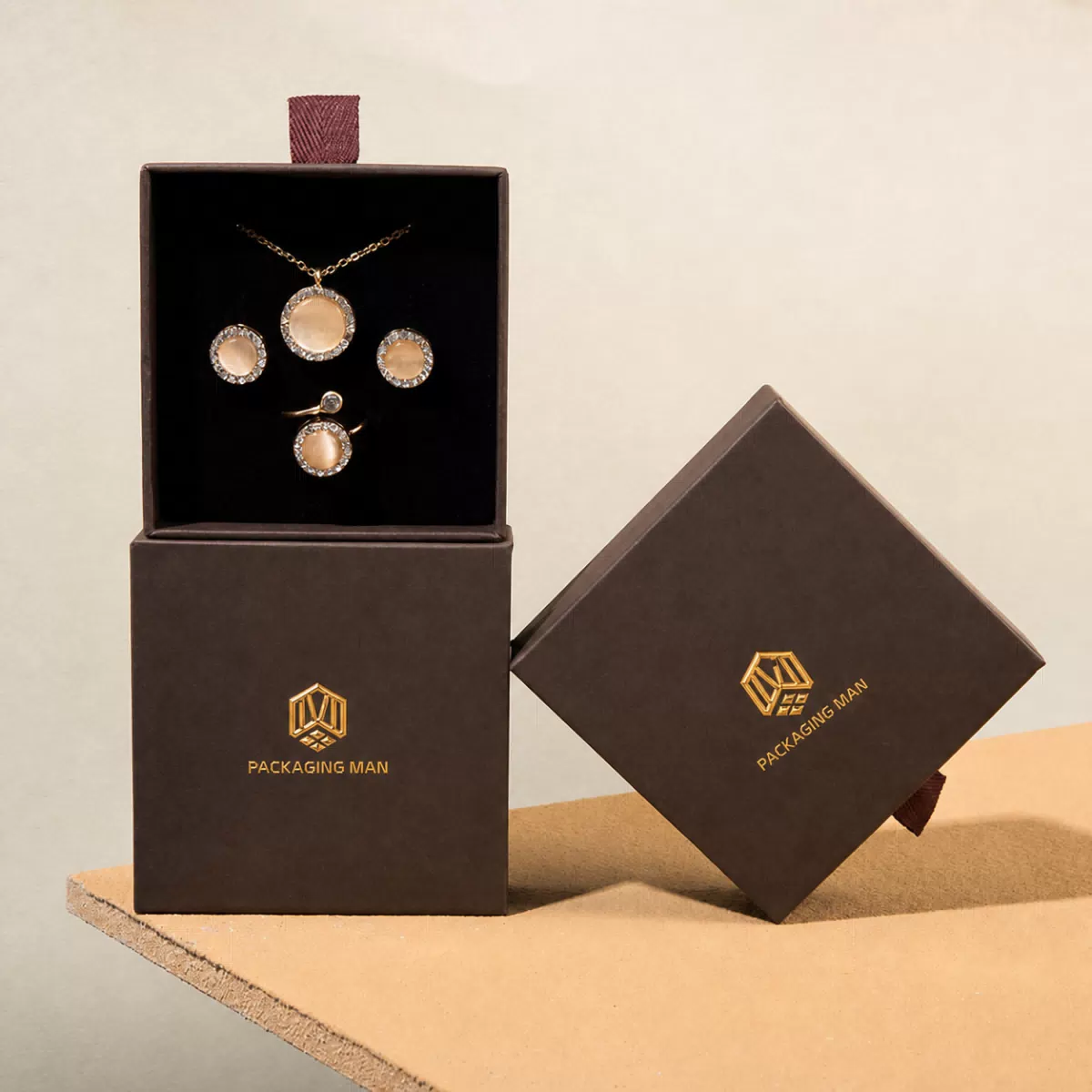 Stacked dark brown drawer boxes with jewelry