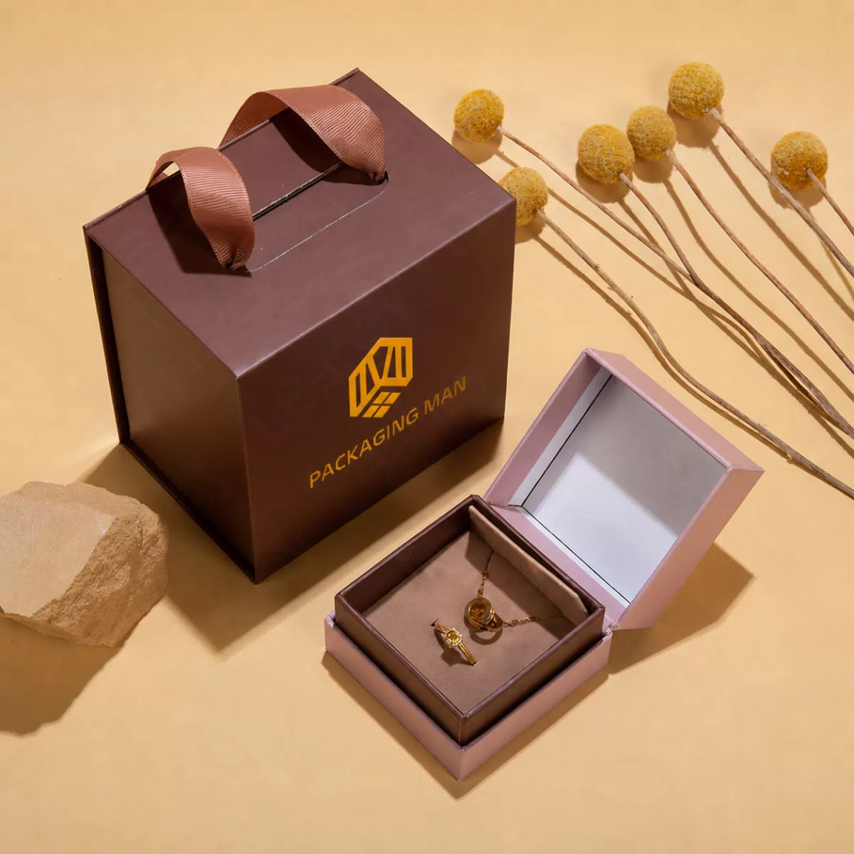 Brown handle box next to open pink box