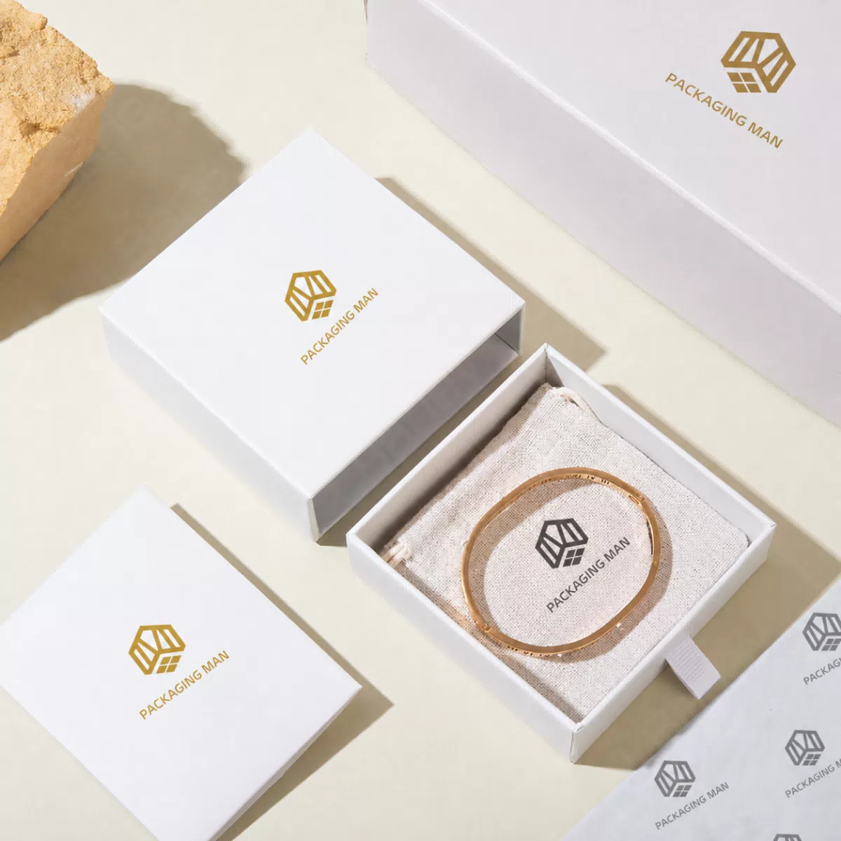 Open white box with bracelet and pouch