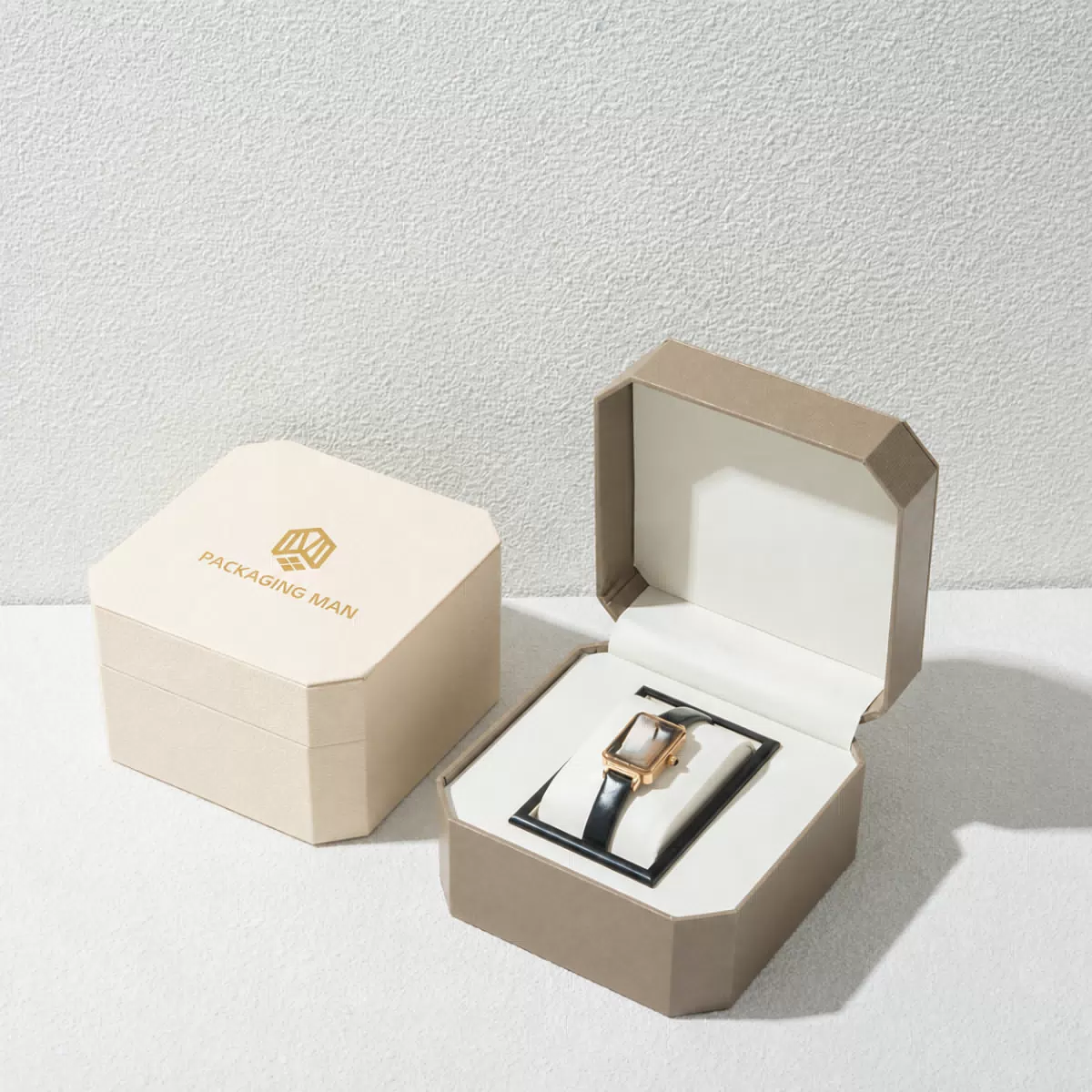 Open beige octagonal gift box with watch insert