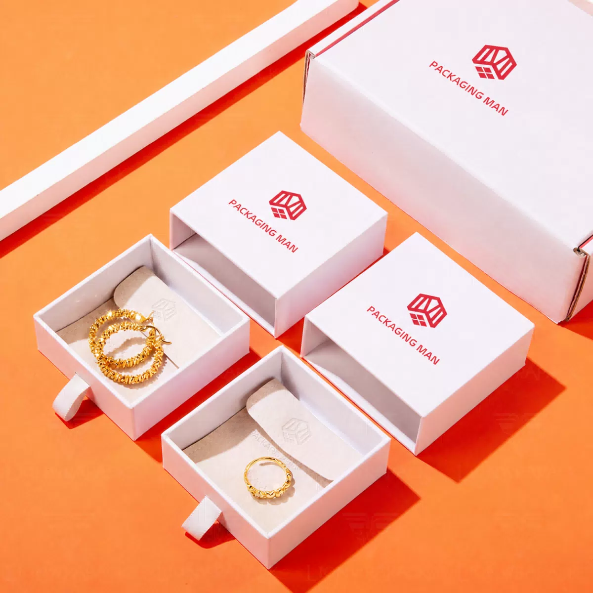 Open white drawer boxes with jewelry inserts