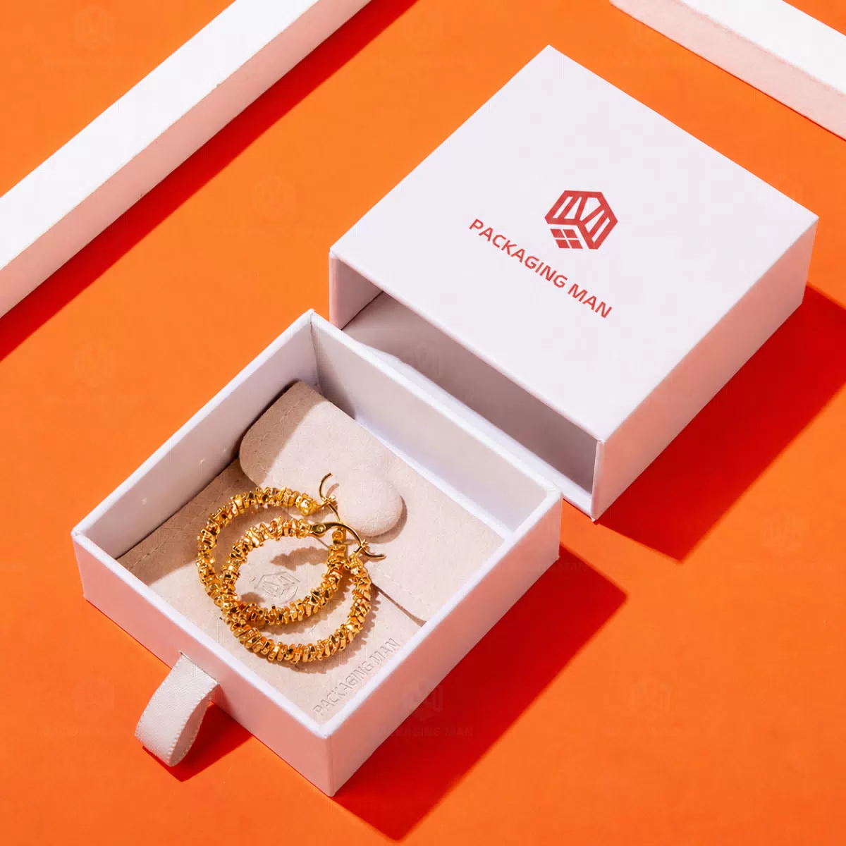 White drawer box with gold earrings inside