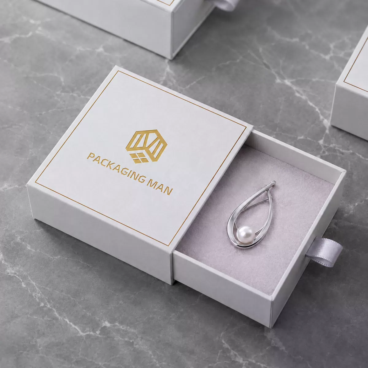 White square drawer box with brooch