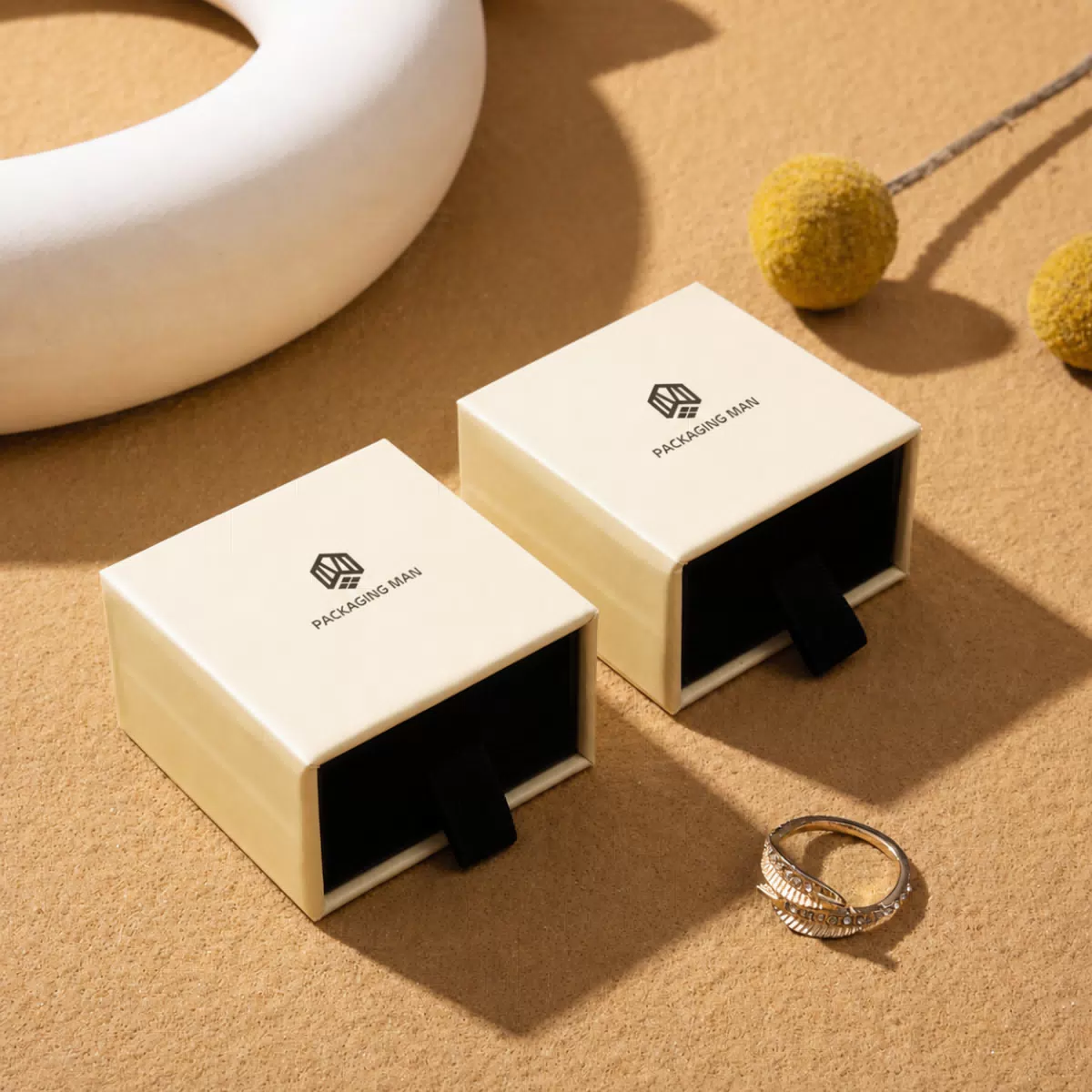Two cream drawer boxes with ring