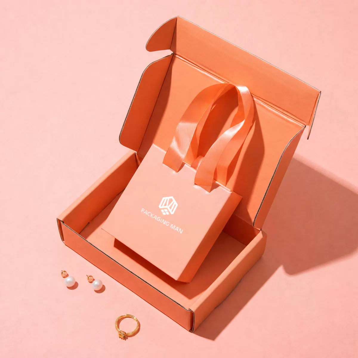 Open orange mailer box with mini bag inside