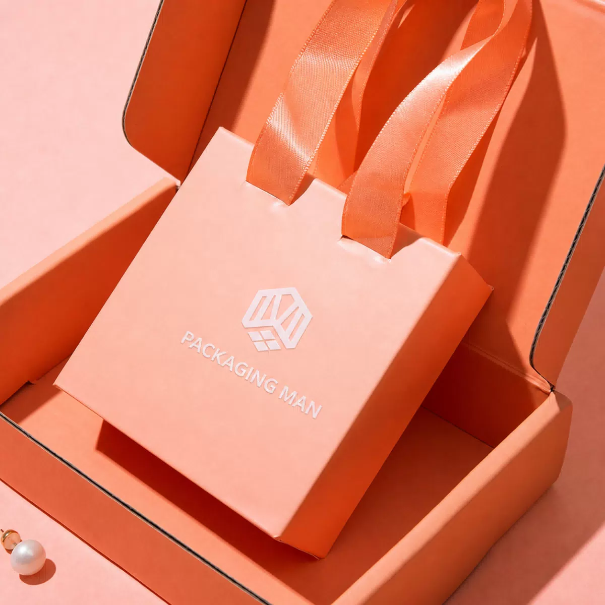 Close up of orange box with ribbon handle bag