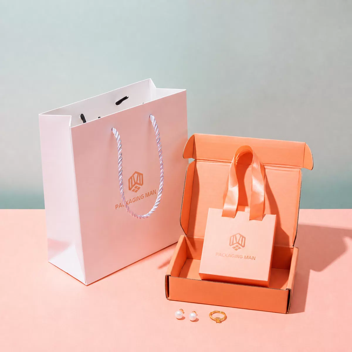 Pink paper bag next to open orange box