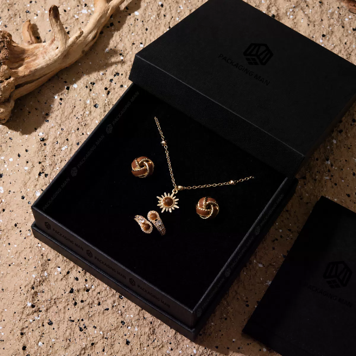 Black rigid box open with gold jewelry