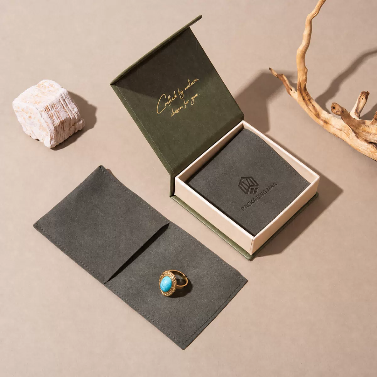 Open green gift box with grey pouch inside