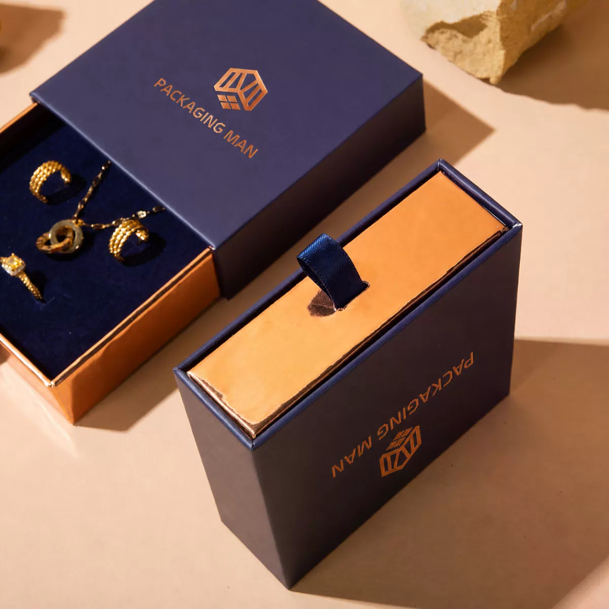 Open dark blue drawer box showing gold tray