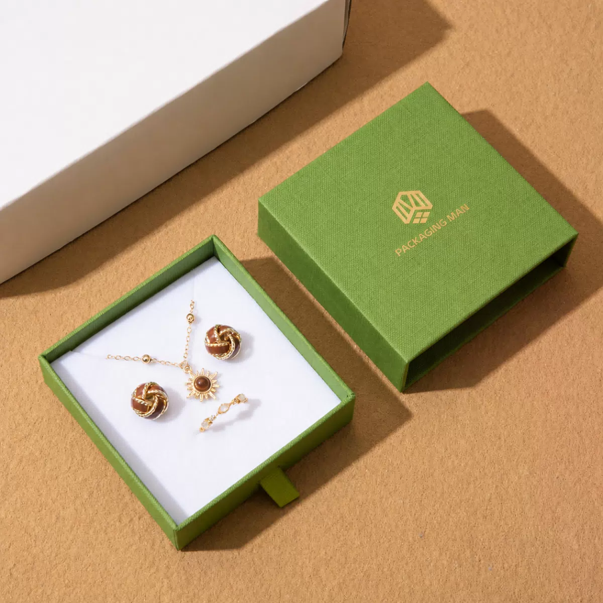 Open green drawer box with jewelry insert
