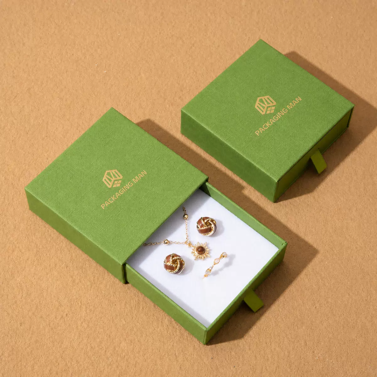 Two green drawer boxes with white interior