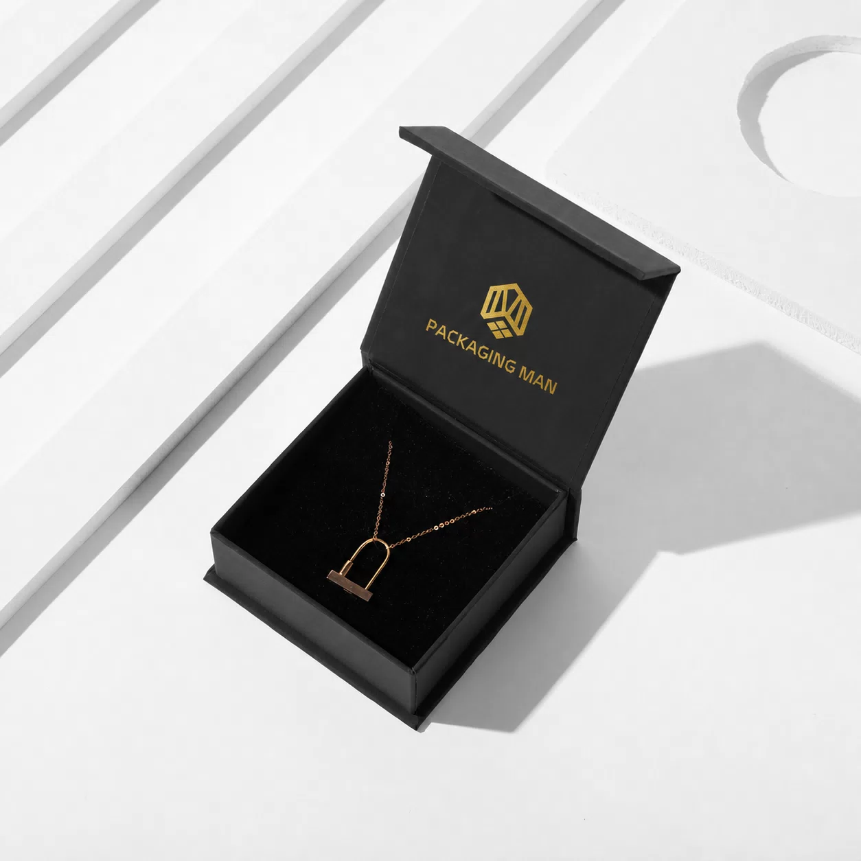 Open black box displaying gold necklace