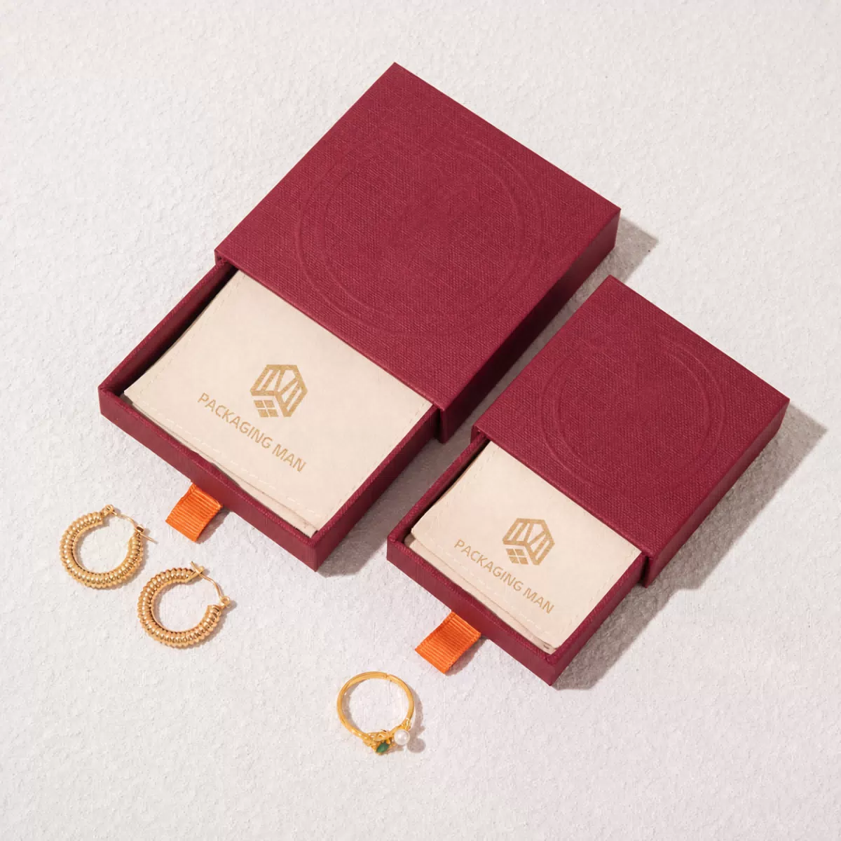 Two burgundy drawer boxes open