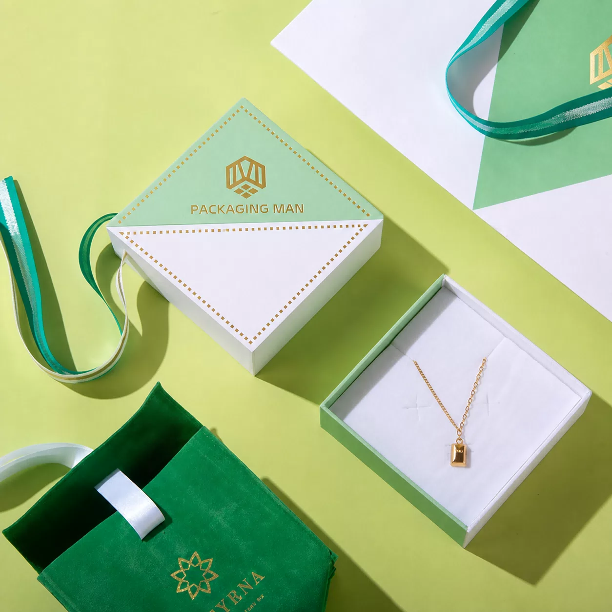 Open rigid gift box with necklace and green pouch