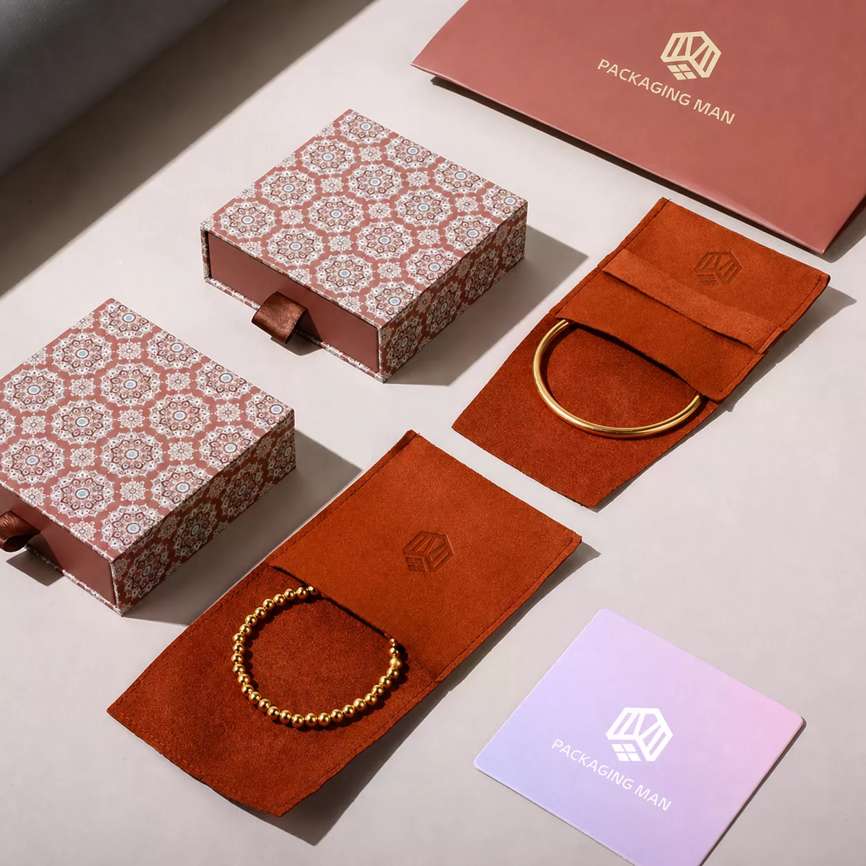 Patterned rigid drawer boxes and suede pouches