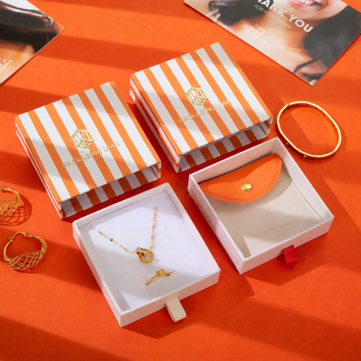 Set of orange striped gift boxes and pouch