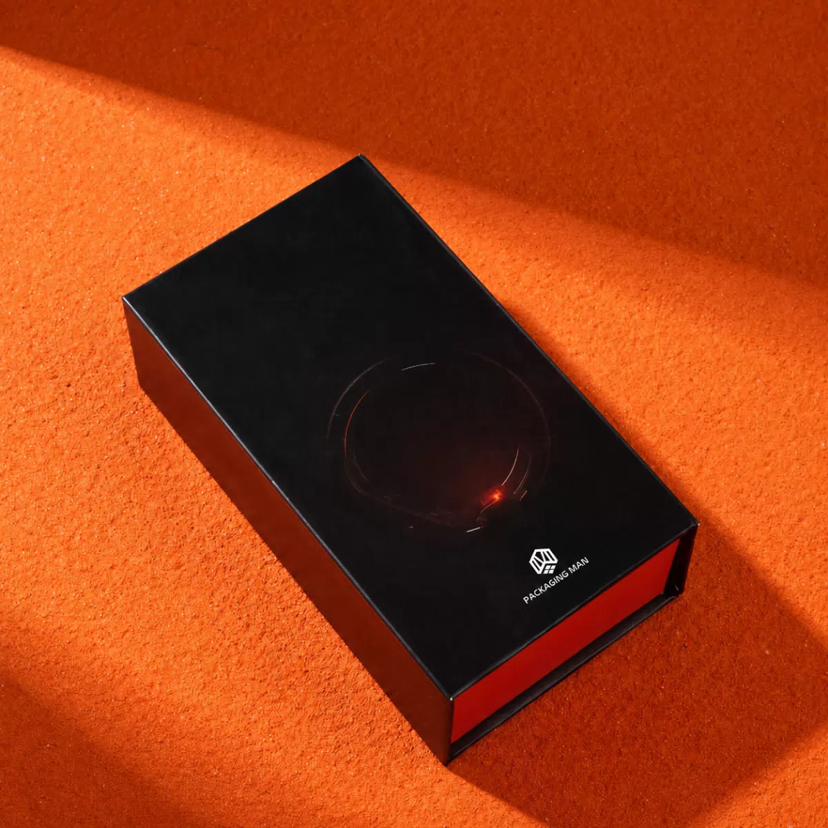 Closed black packaging box on orange background