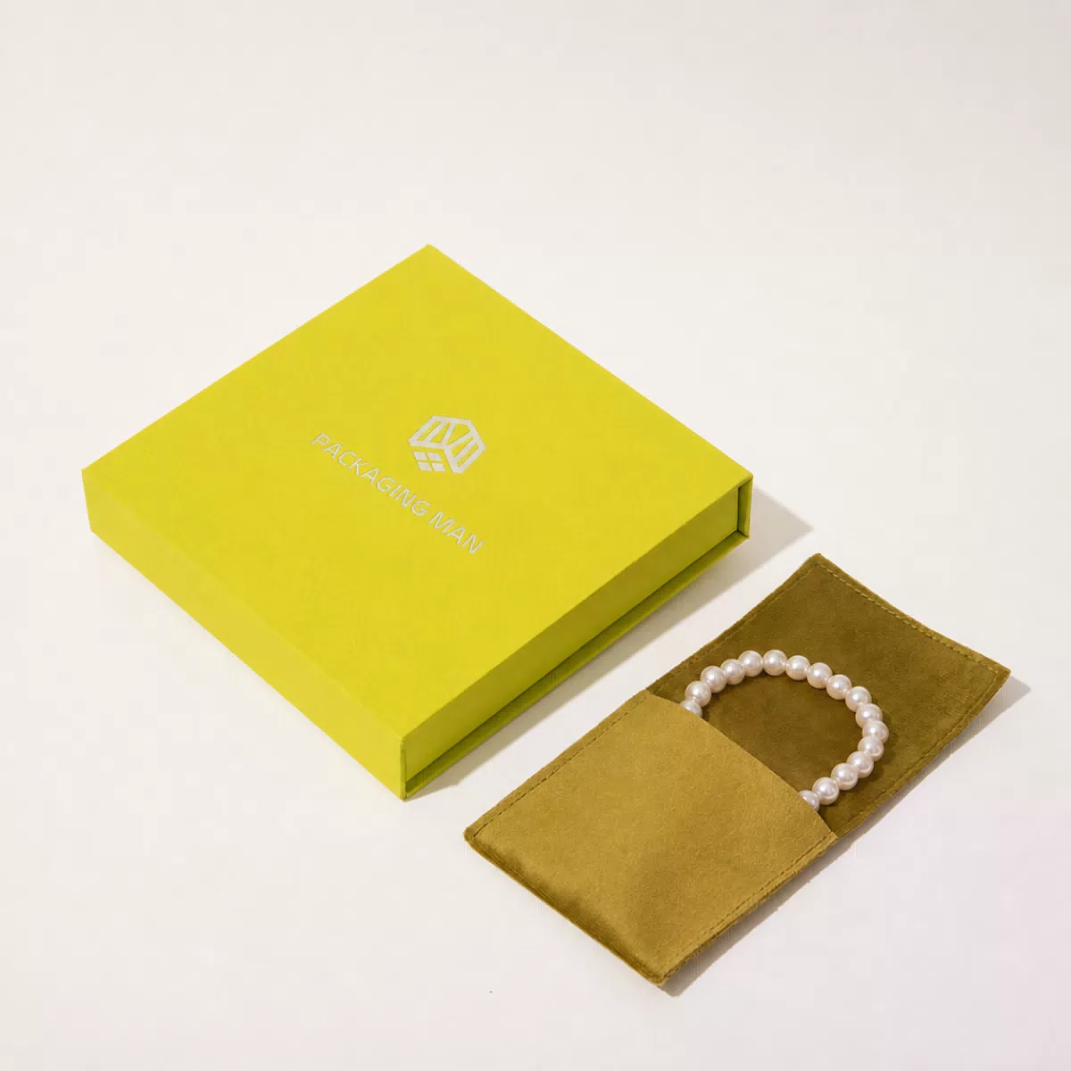Closed chartreuse rigid box and pouch