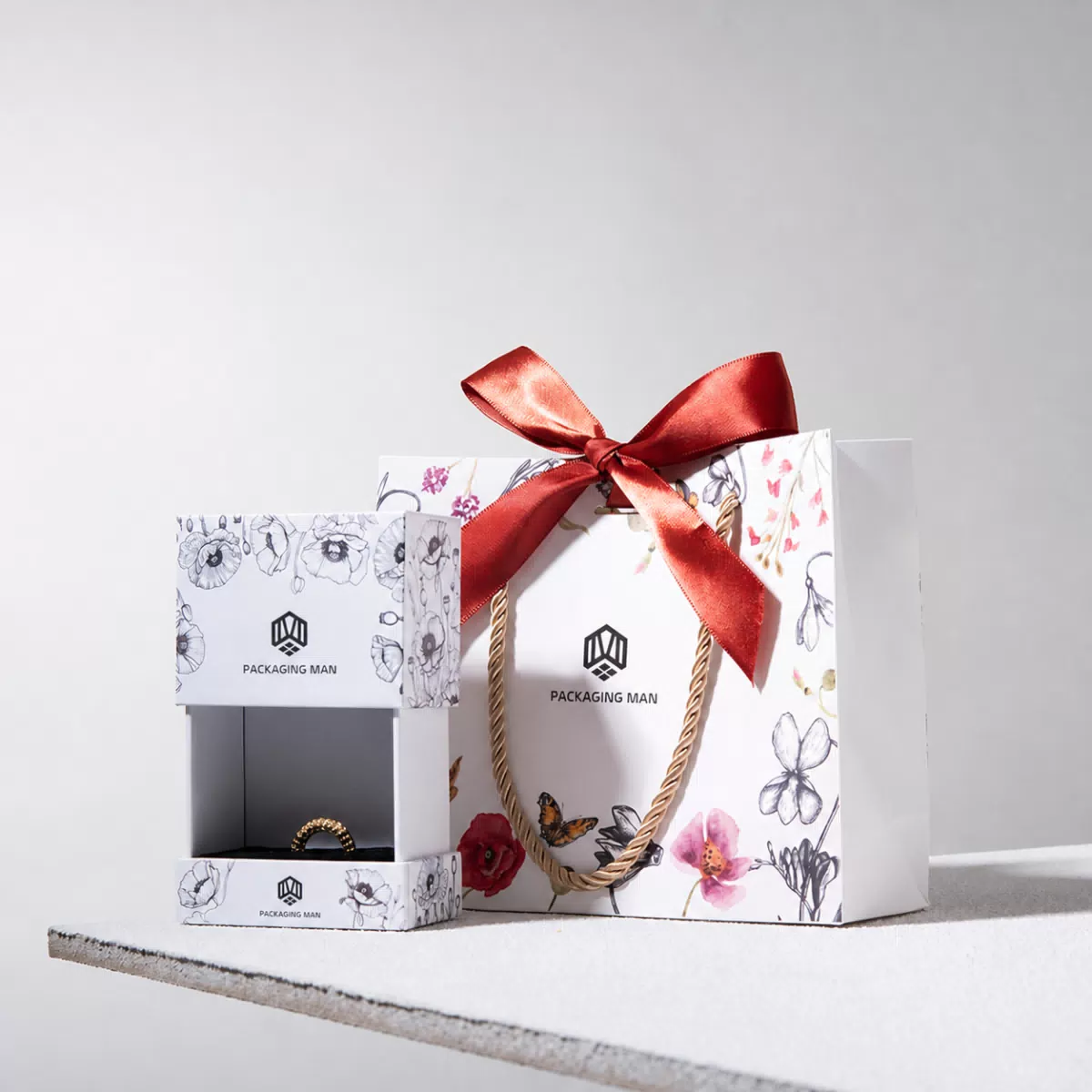 Open floral gift box with ring inside