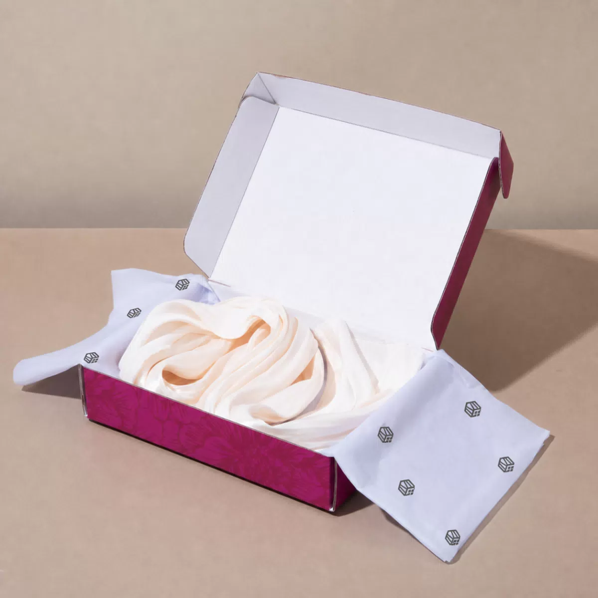 Open magenta packaging box with contents