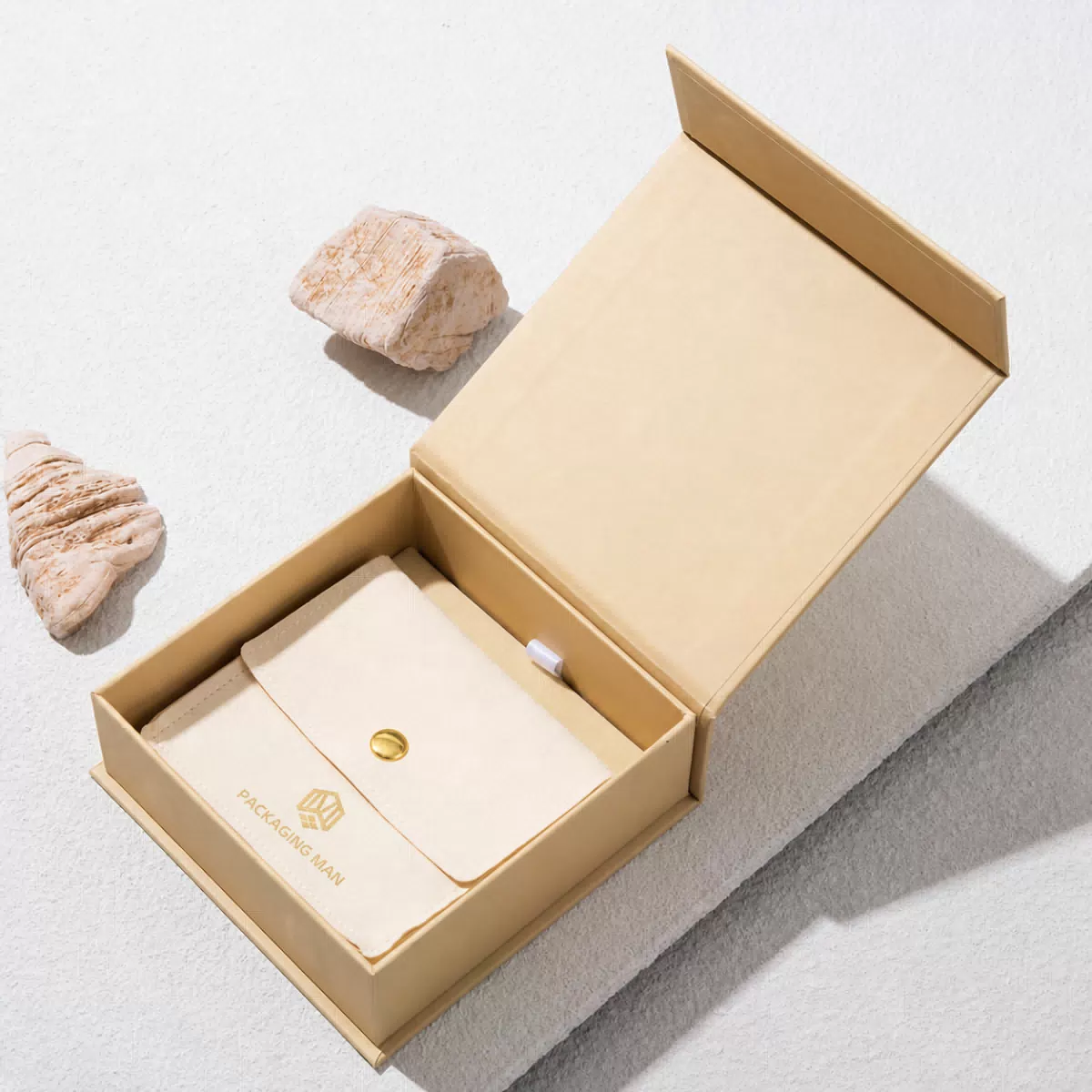 Open beige box with pouch inside