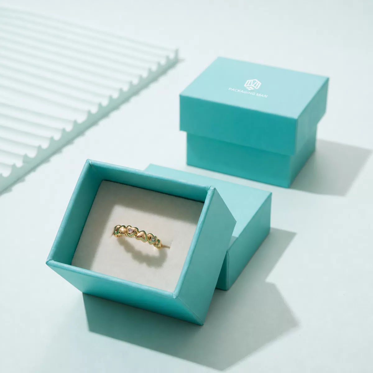 Turquoise rigid box packaging with ring