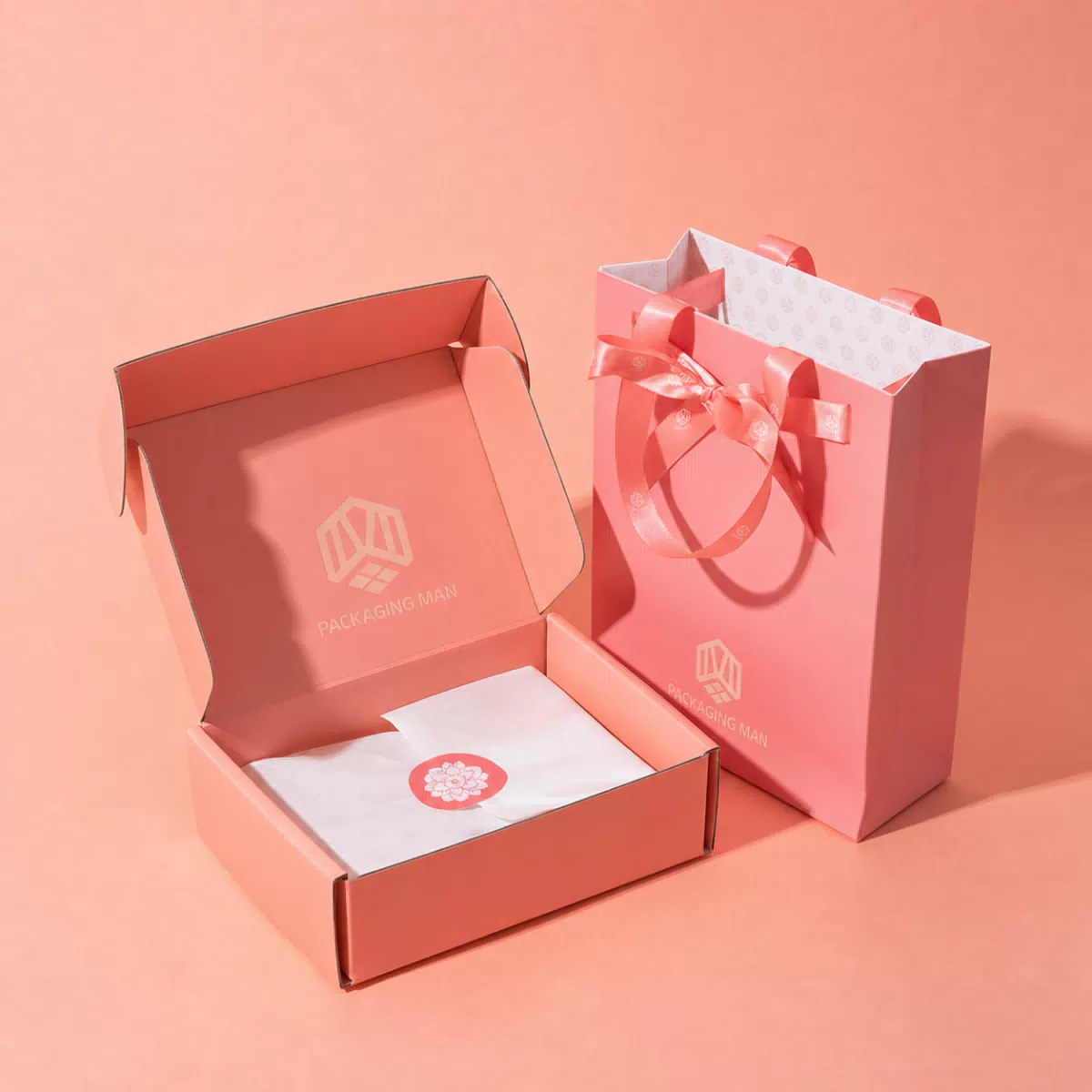 Open pink mailer box and gift bag