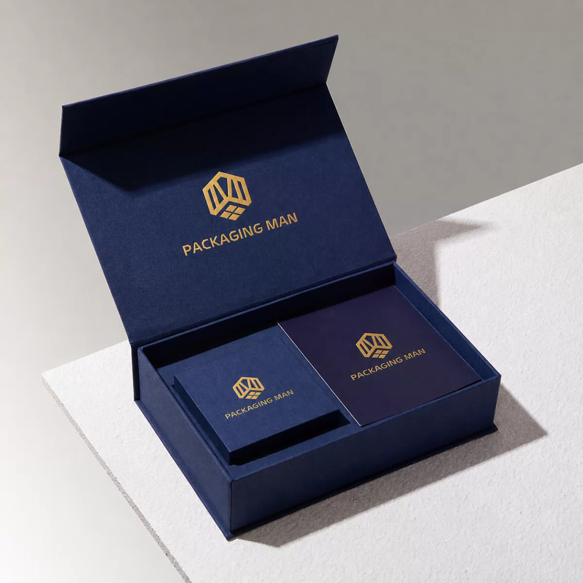 Open dark blue rigid gift box with inner tray